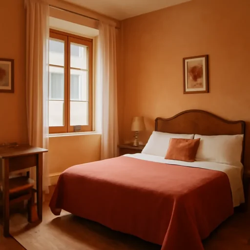 Accogliente camera di B&B a San Lorenzo con arredi essenziali color terracotta e illuminazione naturale